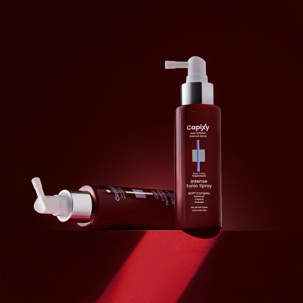 Capixy Intense Tonic Spray applied to the scalp